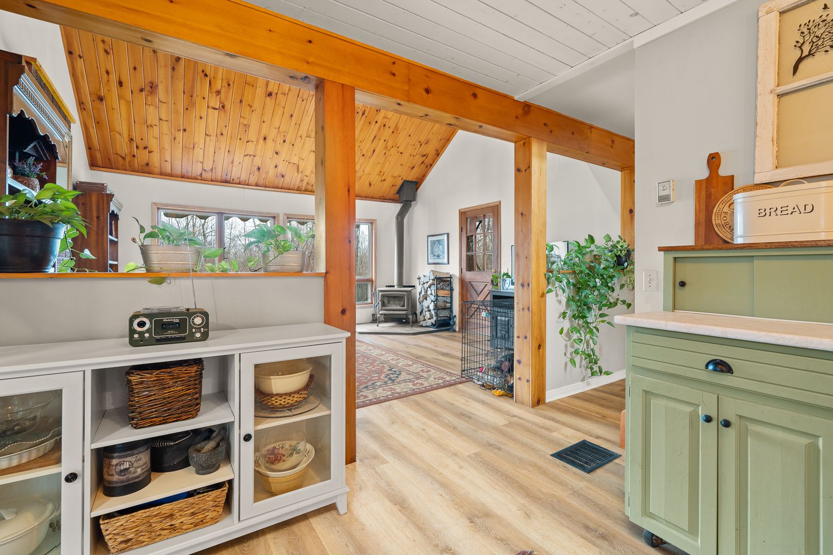 Open living/dining with green cabinets and wood beams at 621 Chapman Strong Road